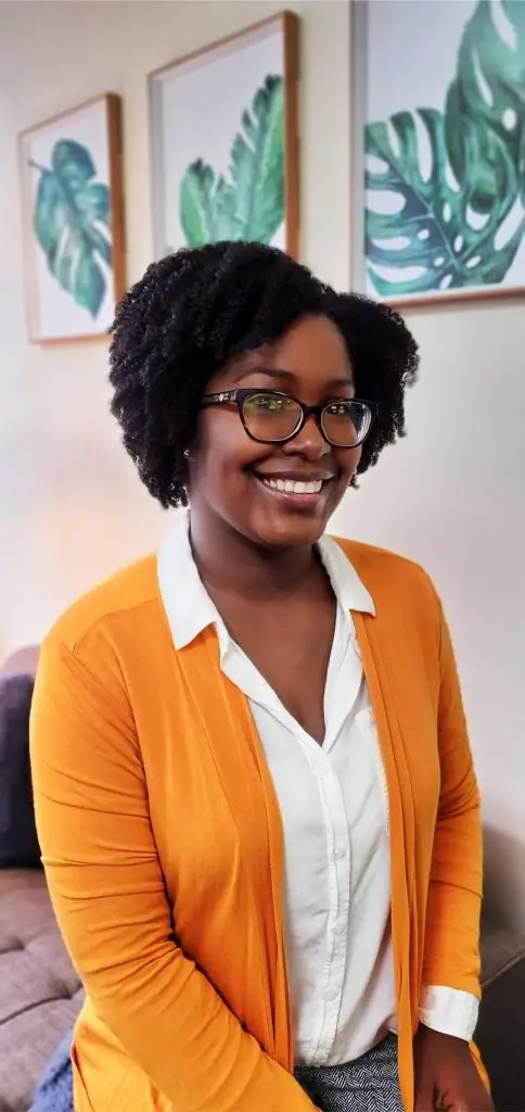 Erica Cannedy, Licensed Professional Counselor in Jersey City, wearing professional attire and smiling warmly at camera. Specializes in anxiety, depression, grief counseling, and substance-related challenges for adults and teens 16+